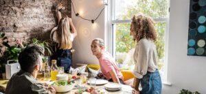 young-friends-about-to-sit-down-for-a-meal