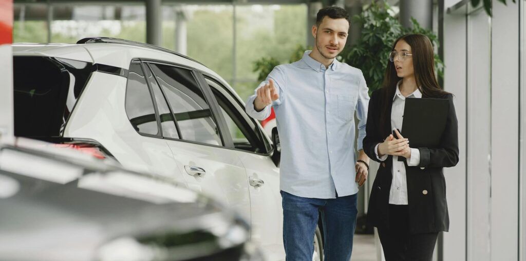 A_Man_Asking_Salesperson_at_Car_Showroom