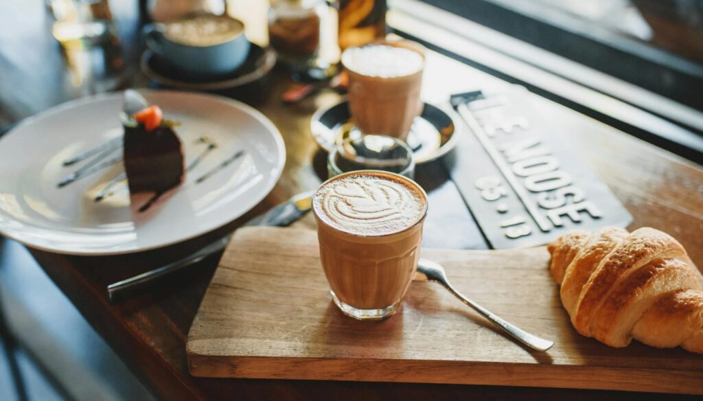 Two_Cups_of_Cappuccino_with_Croissant_on_Table