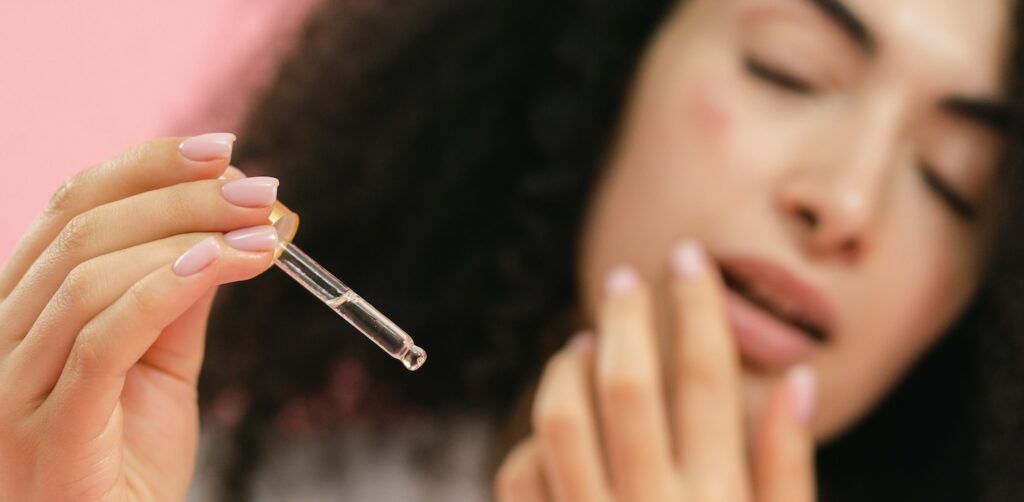 A_Woman_Holding_a_Serum_on_a_Dropper