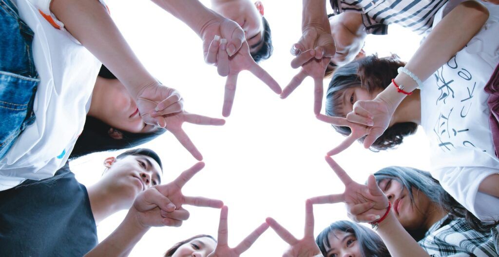 Group_of_People_Forming_Star_Using_Their_Hands