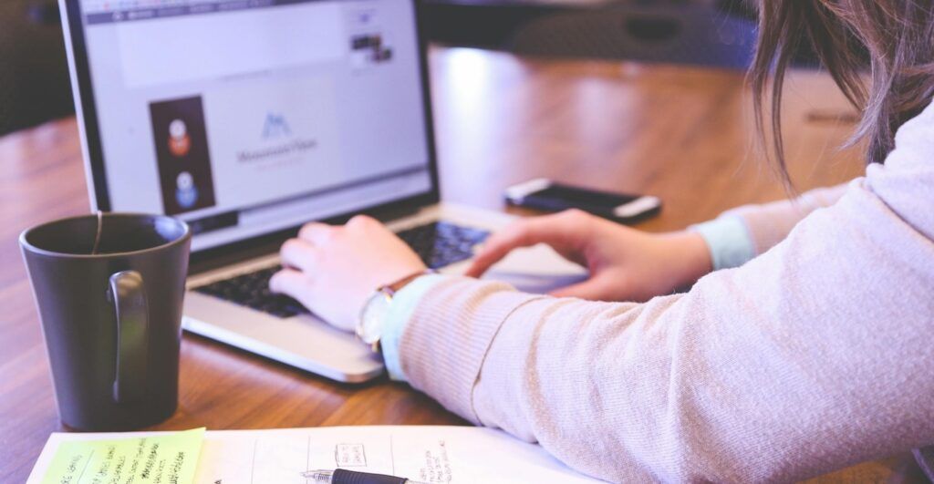 A_Woman_Using_Laptop_Writing_Articles A_Woman_Using_Laptop_Writing_Articles