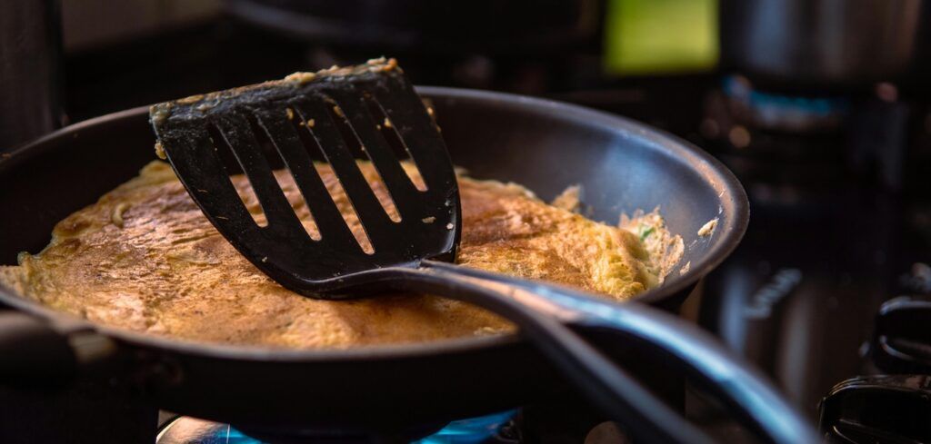 Cooking_Omelette_On_Black_Frying_Pan Cooking_Omelette_On_Black_Frying_Pan