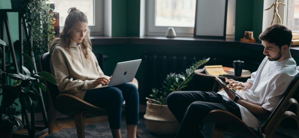 Two_People_Using_Laptop_and_Tablet
