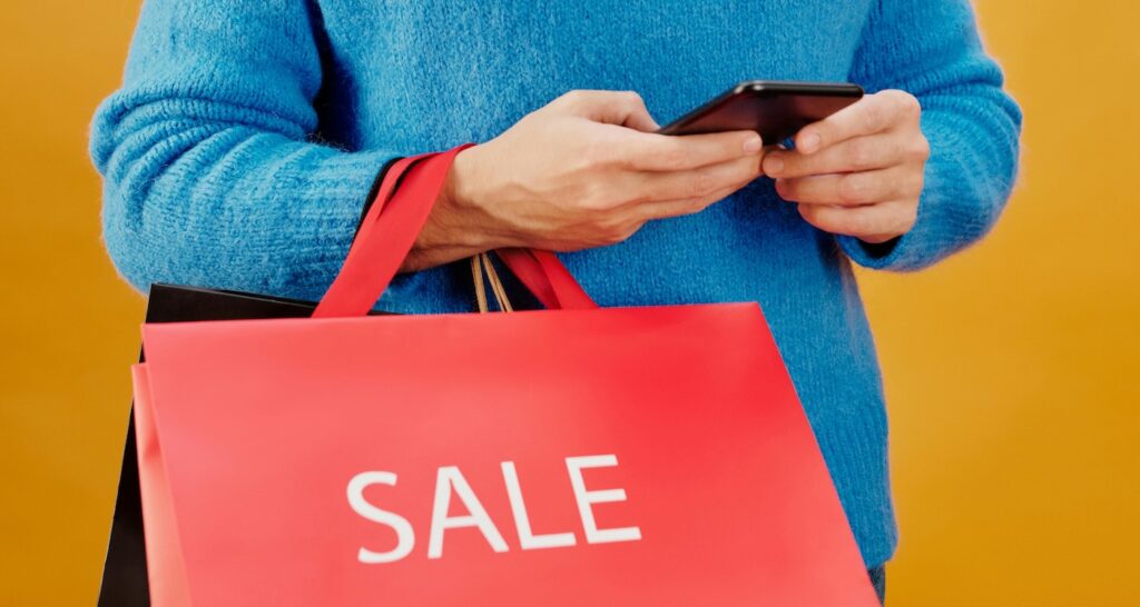 Man in Blue Sweater Holding a Paper Bag Man in Blue Sweater Holding a Paper Bag