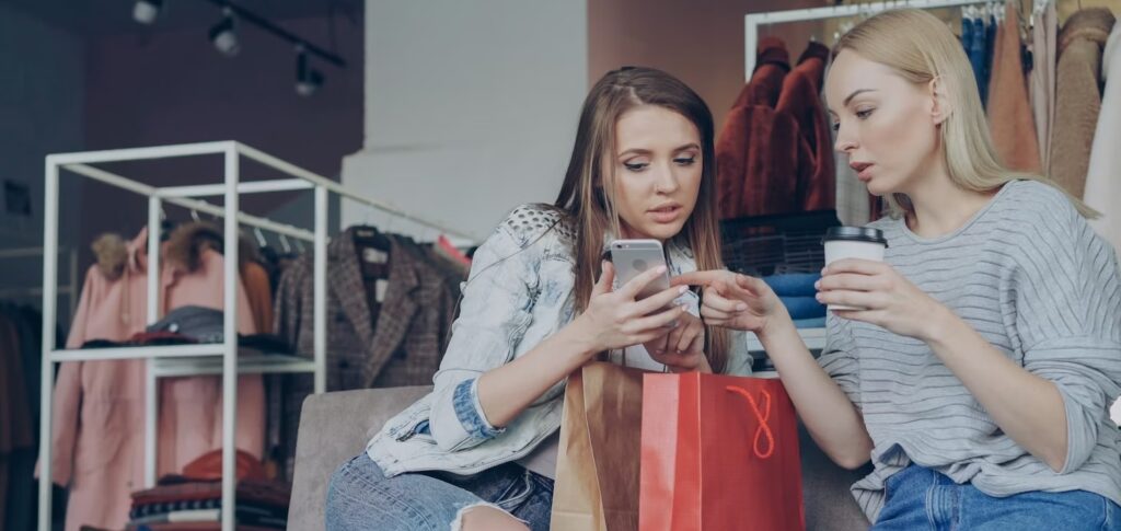 Women checking smartphone and talking