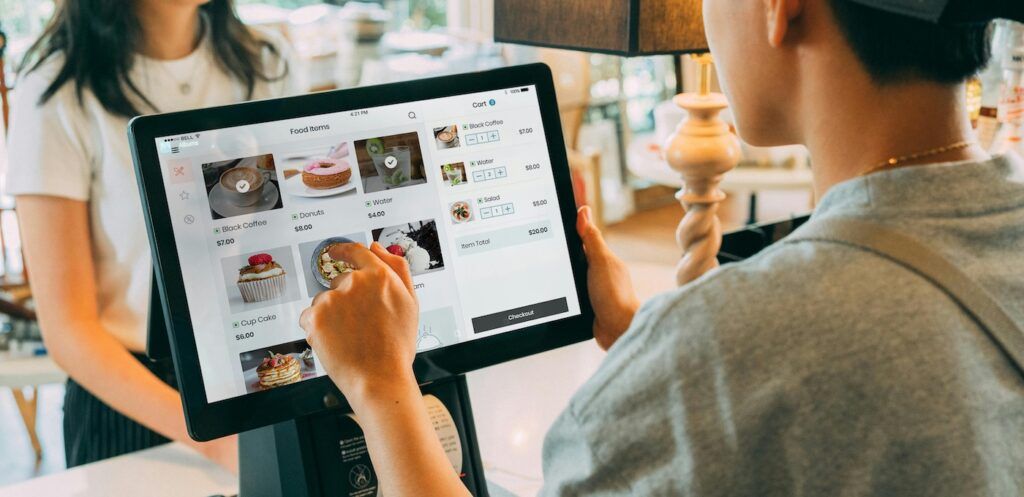Cashier Using a Point of Sale System Cashier Using a Point of Sale System