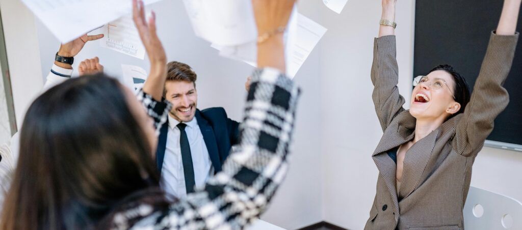 Coworkers Tossing Papers at an Office Coworkers Tossing Papers at an Office