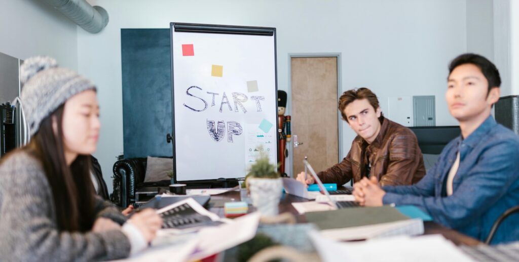 Man Sitting Beside Woman in Meeting Room