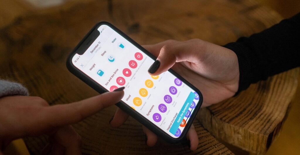 A Woman Holding a Smartphone with App on the Screen