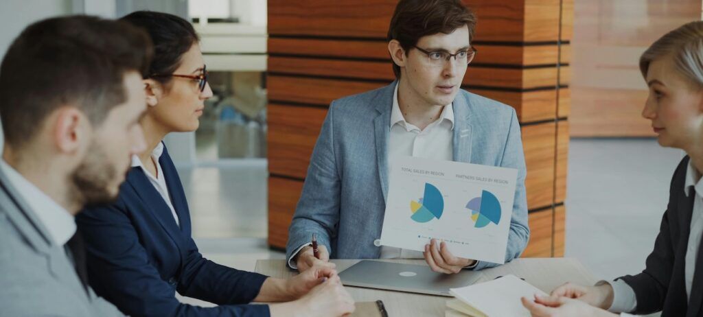 Business Team Analyzing Sales Data in Meeting