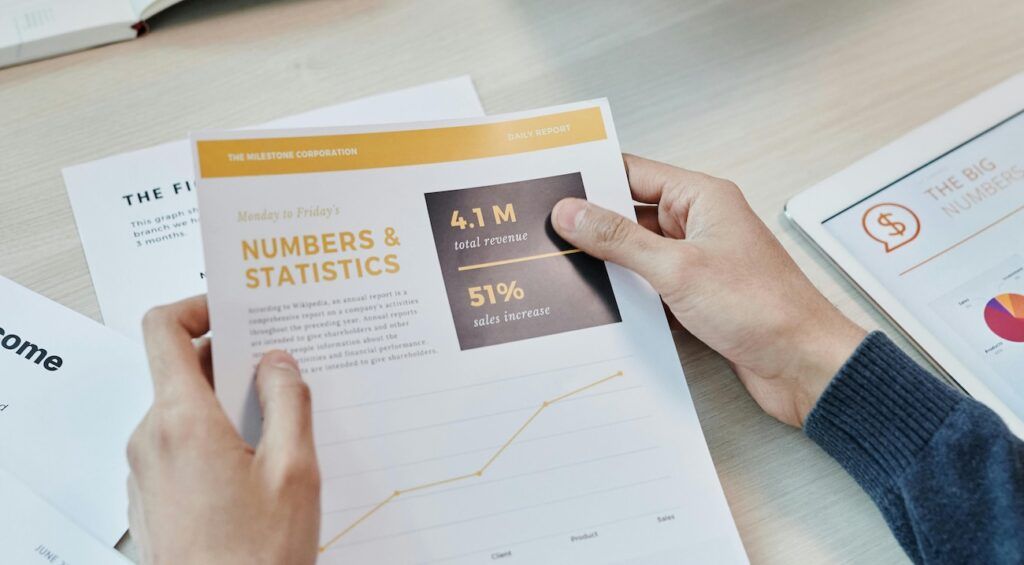 a-man-holding-sales-report a-man-holding-sales-report