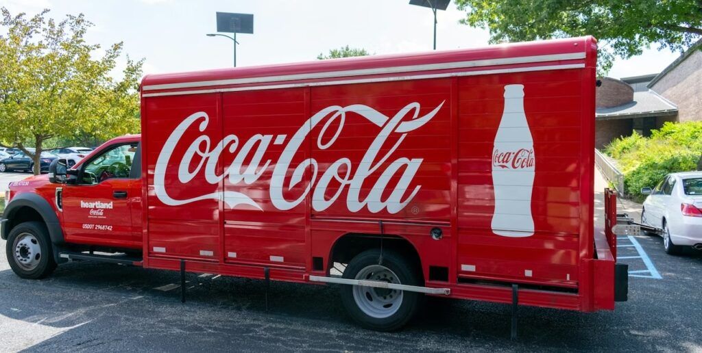 the side of a red Coca-Cola delivery truck