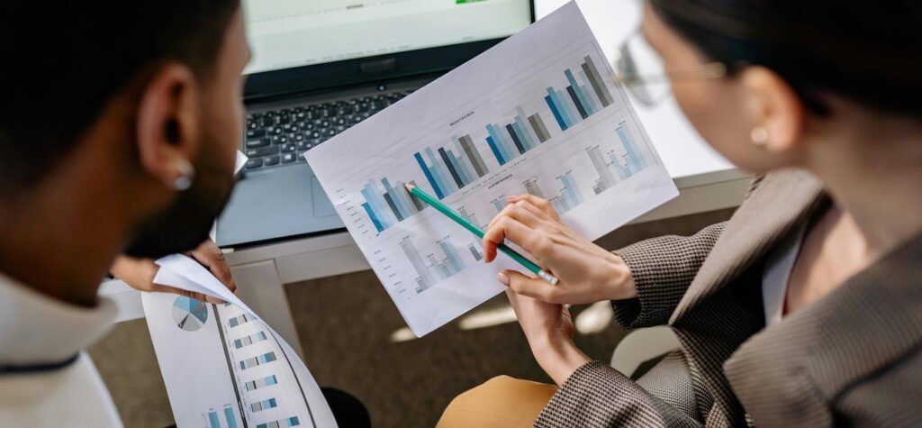 two-people-discussing-data-sheet