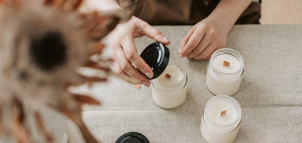 A close-up shot of a person making handmade candles