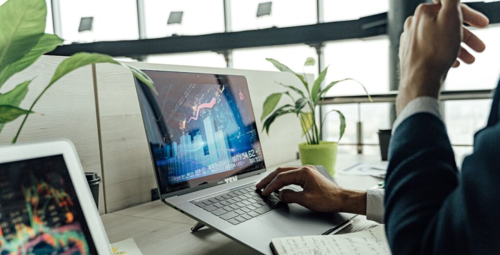 A professional analyzing stock market data on a laptop A professional analyzing stock market data on a laptop