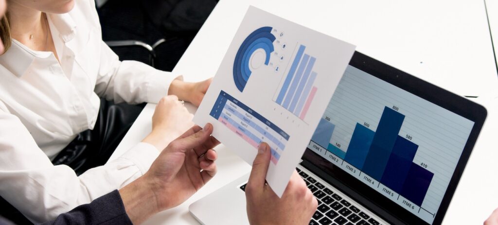 Employee discussing data charts and graphs Employee discussing data charts and graphs