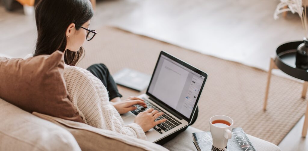 Woman working remotely on a laptop Woman working remotely on a laptop