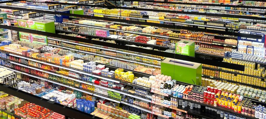 view of supermarket aisles filled with colorful products view of supermarket aisles filled with colorful products