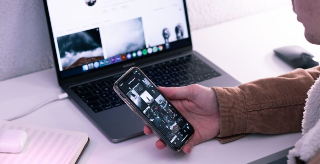 a man using smartphone and laptop with social media a man using smartphone and laptop with social media