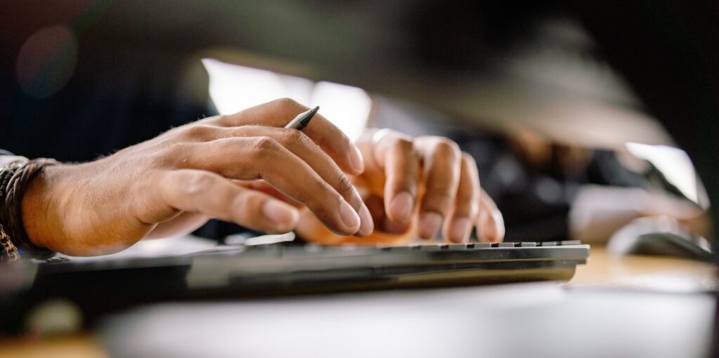 a person typing on a keyboard, emphasizing productivity and office work a person typing on a keyboard, emphasizing productivity and office work