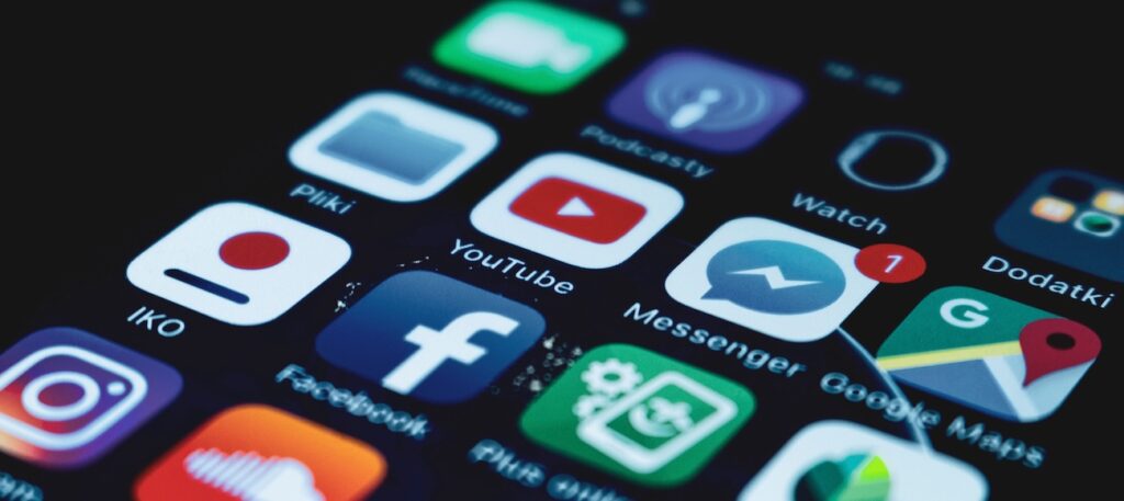 a smartphone screen displaying various popular social media app icons. a smartphone screen displaying various popular social media app icons