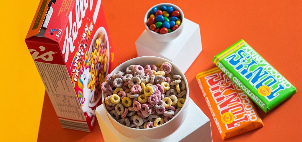 A vibrant flat lay of colorful breakfast cereals, chocolate bars, and candy A vibrant flat lay of colorful breakfast cereals, chocolate bars, and candy