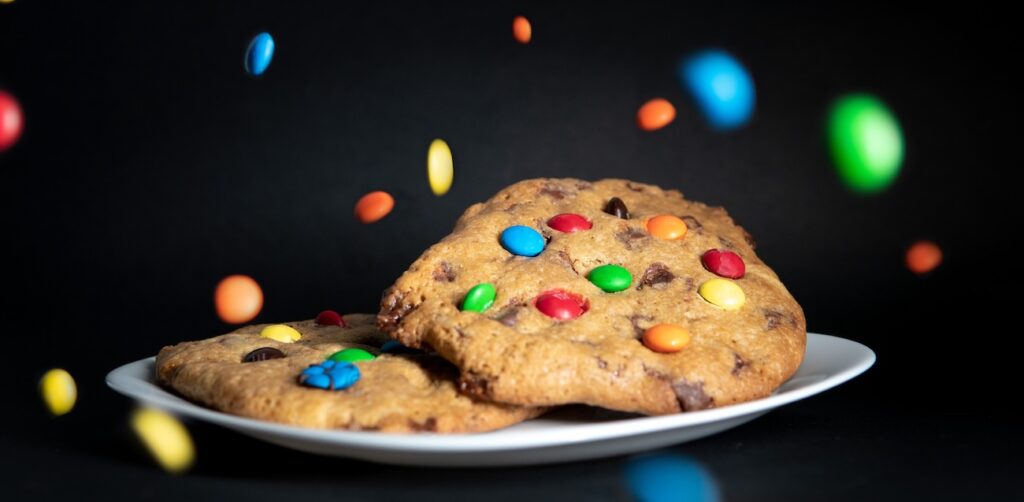 cookies with colorful candy toppings on a white plate cookies with colorful candy toppings on a white plate