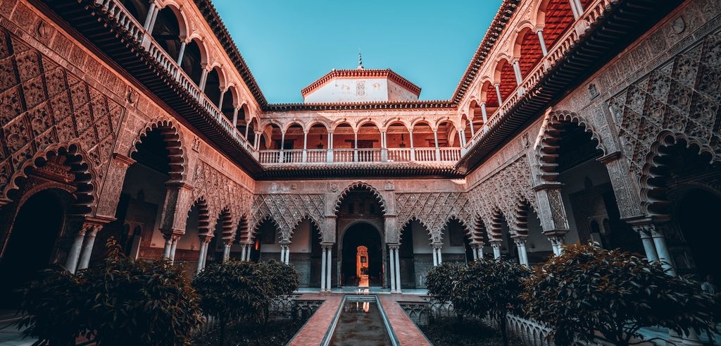 view of the intricate courtyard architecture at Alcázar of Seville in Spain view of the intricate courtyard architecture at Alcázar of Seville in Spain