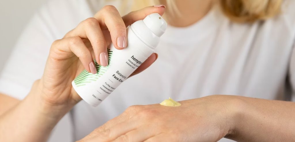 a woman using hand cream product a woman using hand cream product